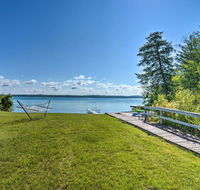 Torch Lake Home with 116ft of Blue Water Access